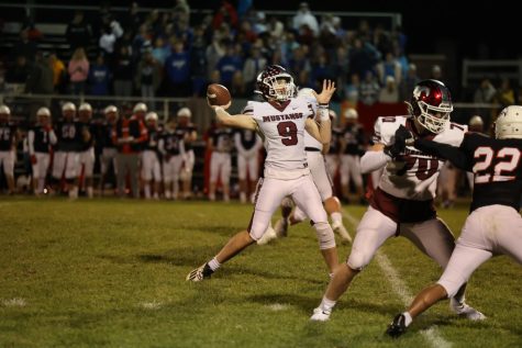 Varsity starting quarterback Joey Rhomberg(9) doing what he does best.