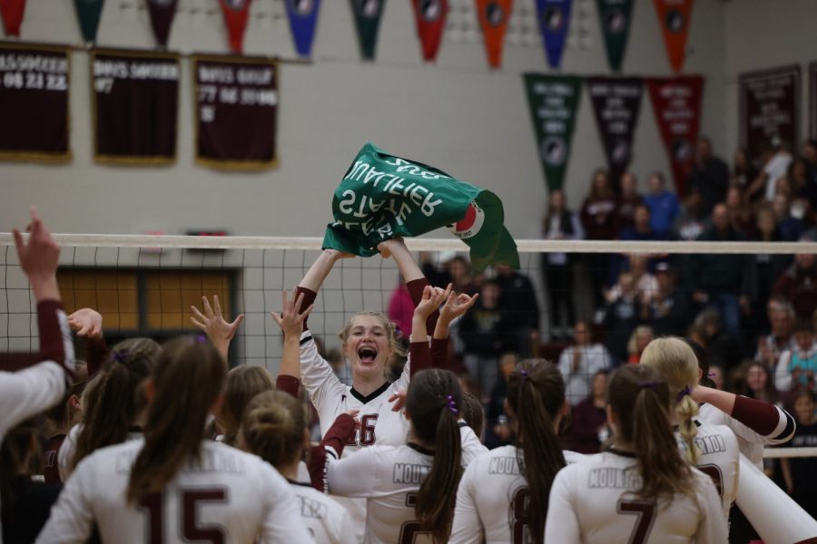 Sophomore Chloe Meester waves the newly won banner amidst celebration from the rest of her team.