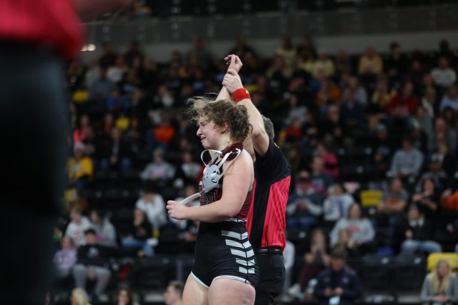 Sophomore Libby Dix raises her hand after pinning her opponent, securing a spot in the state finals on Feb 3. Dix was Mount Vernons first girls wrestling state finalist.