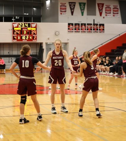 Courtney and Taylor Franck congratulate their teammate, Chloe Meester, after a free throw. 