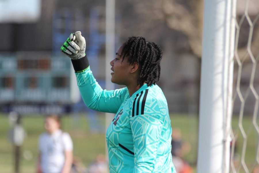 Varsity goalie Cana Safo encourages her teammates to keep the energy up during the second half of the Solon game on April 11. The Mustangs lost 2-0.