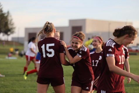 Freshman Taylor Franck and her teamates celebrate to winning against the Washington Warriors 6-1 on April 13.