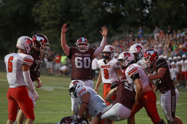 Senior Tavian Gorsh (60) celebrates a play that leads to a touchdown on Aug 25. The Mustangs won 35-6 against the Monticello Panthers.