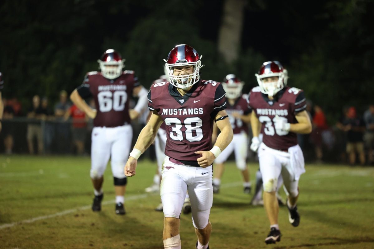 Senior Benny Pospisil (38) runs to the sideline to bring the energy up after a play.
