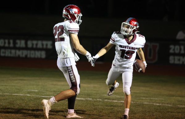 Juniors Ethan Wood (22) and Cole Thurn (19) celebrate the play with a handshake.