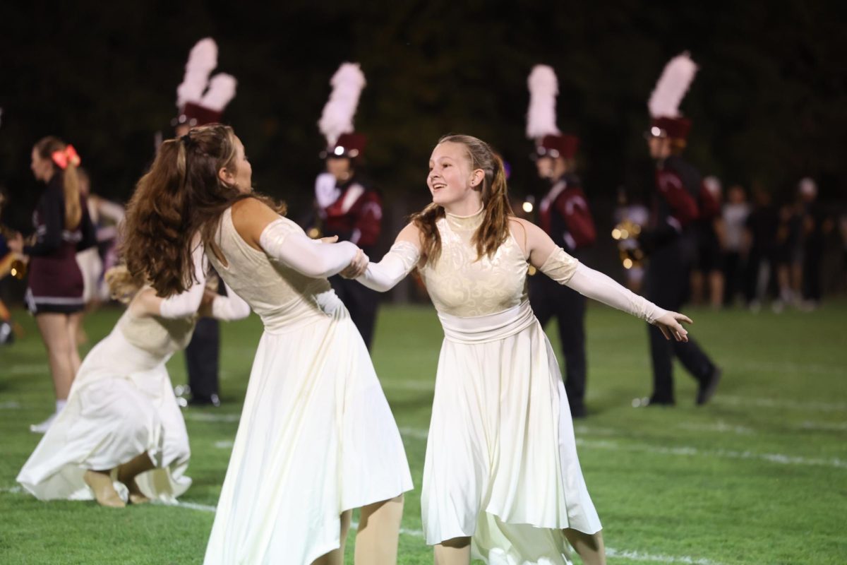 Juniors Violet Olinger and Isabella Hasley act out their choreography at the beginning of the bands performance.