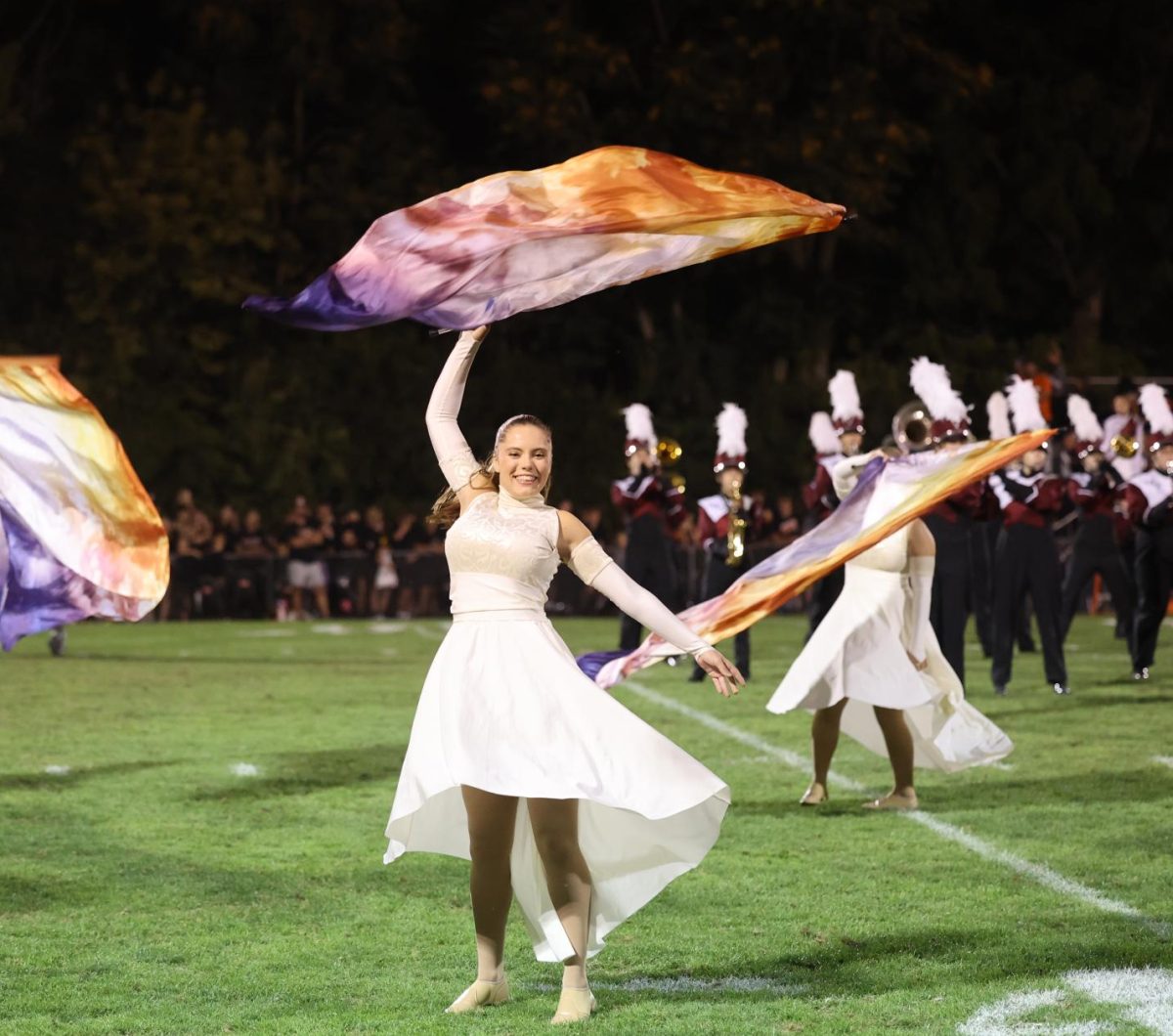 Junior Renee Vig extravagantly twirls her flag during the bands show.