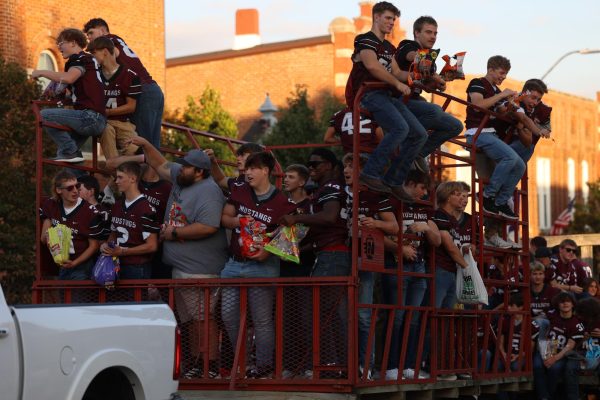 The MVHS football team throw candy to their peers in the homecoming parade. 