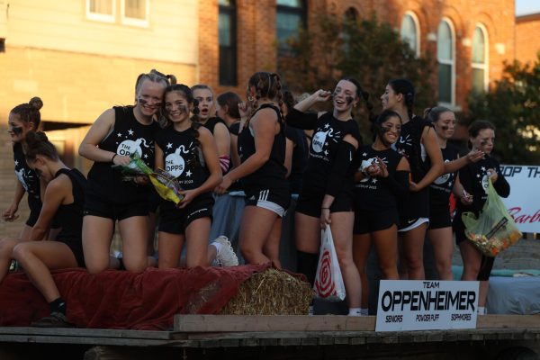 The sophomore and senior powderpuff team ride on their float in the homecoming parade on Sept. 28 