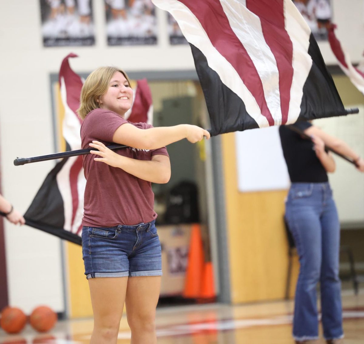 Sophomore Mae Krapfl performs with the color guard at the end of the MV pep rally on Sept. 29. 