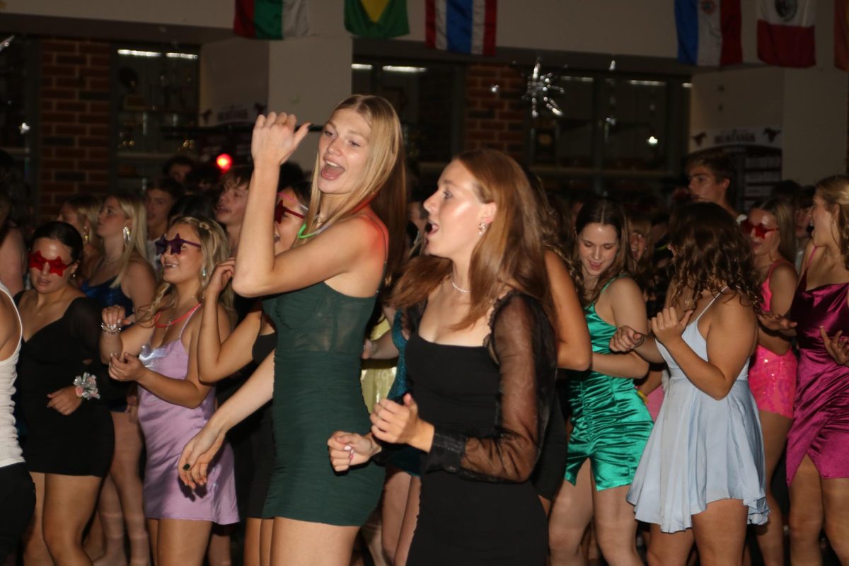 Juniors Chloe Meester and Hailey Bock dance to the Cupid Shuffle.