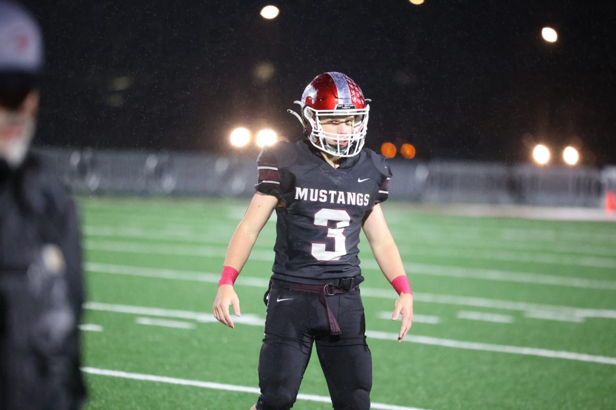 Unbothered by the cold rain, sophomore Mikey Ryan(3) is ready for whats to come. The Mustangs destroyed the Washington Demons 65-6 on Oct. 13.