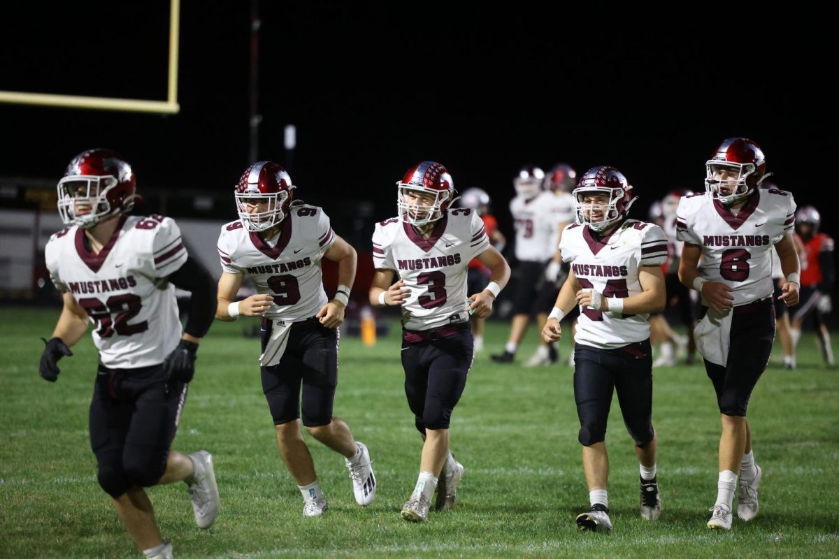 After sophomore Mikey Ryan(3) turns the ball over in the opposing endzone, making a 100-yd run for a touchdown, Ryan and his teammates come off the field to the sideline laughing in disbelief. The Mustangs beat the Fort Madison Bloodhounds 45-7 on Oct 6.