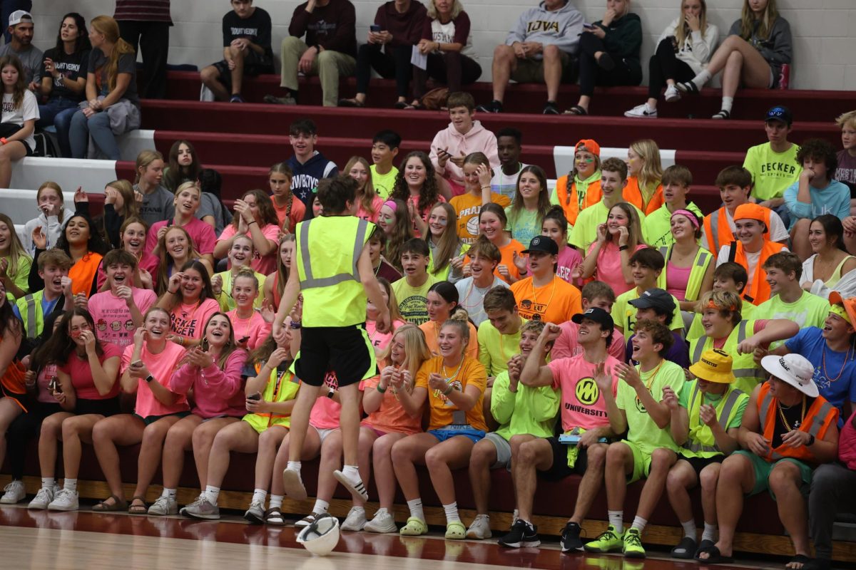 The student section, led by Gabriel Fairchild, gets their energy up before the 3rd set.