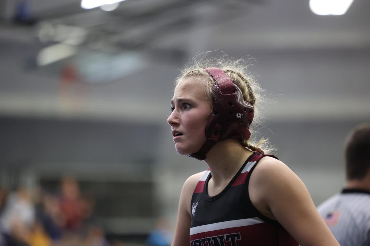 Senior Audrey Tucker gives her coaches a shocked look when she found out that she had won. Tucker finished 3rd at 115. 