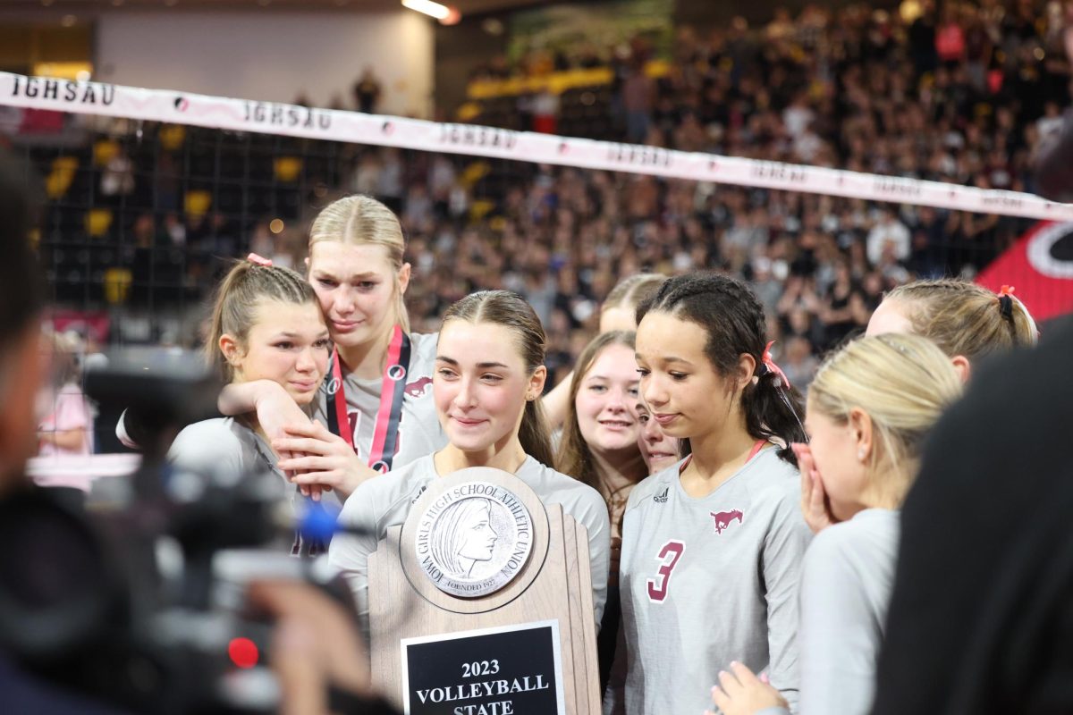 The team celebrates while receiving the second place trophy. The Wolfpack beat the Mustangs 3-1 (25-23, 22-25, 25-22, 25-18). 