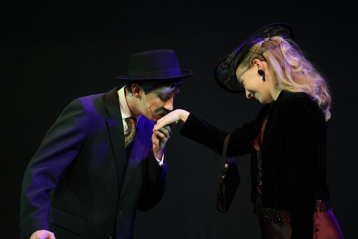 Senior Luke Stephens (Hercule Poirot) places a kiss on the hand of junior Natalie Thuerauf (Countess Andreny). 
The play, Murder on the Orient Express, was preformed on Nov. , Saturday 5th and Sunday 6th.