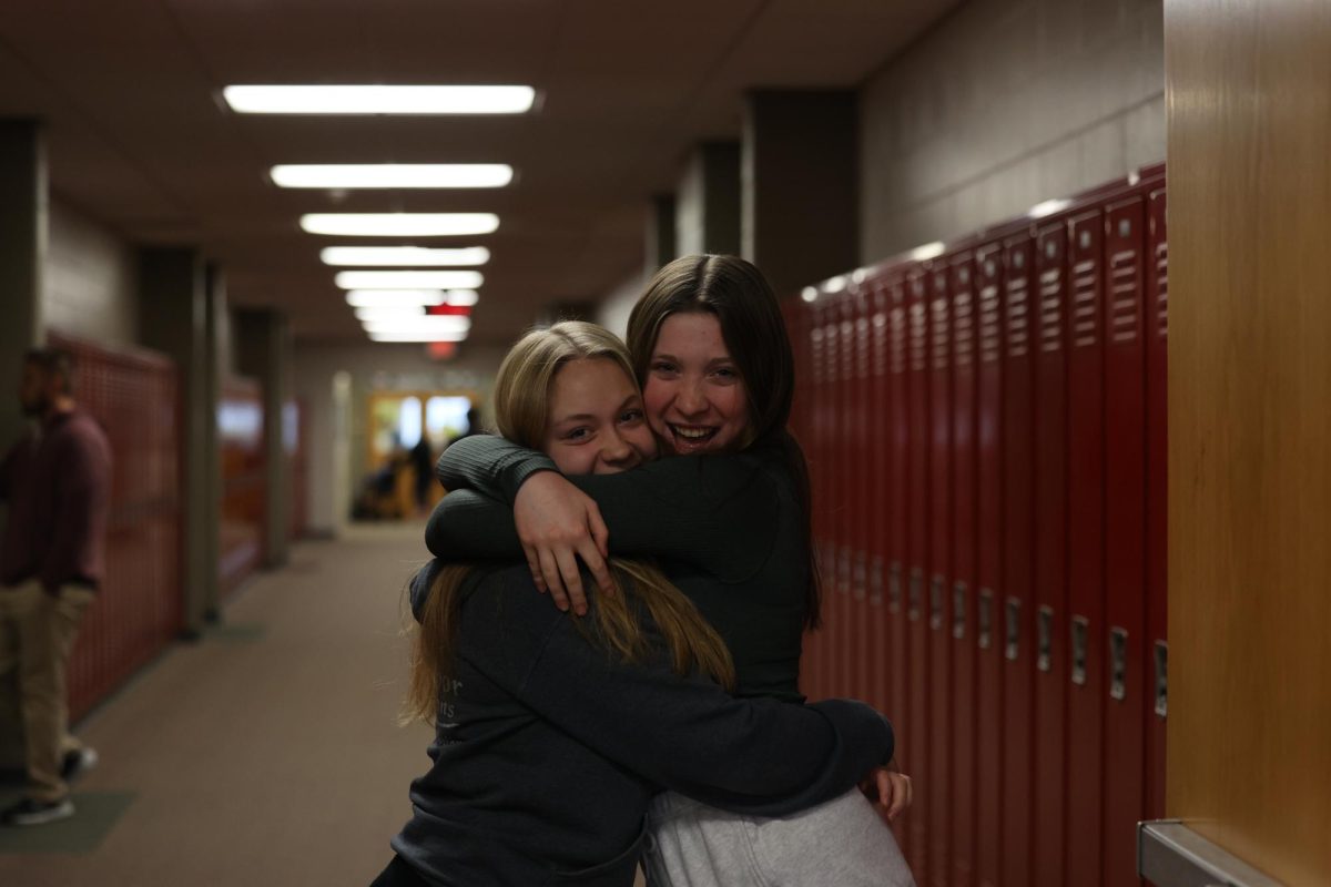 Sophomores Malena Koehn and Bella Manternach embrace in the hallway on Jan. 3 during their first day of j-term. 