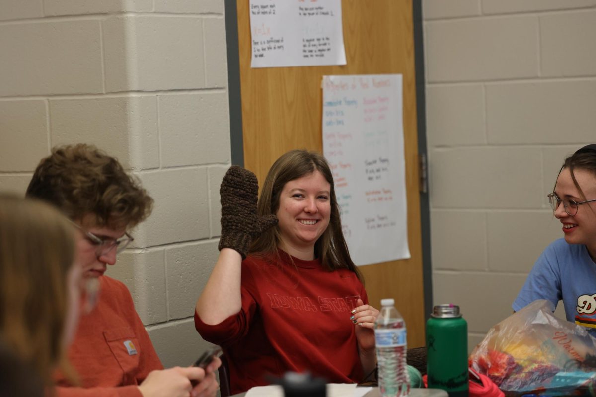 Junior Selah Loyd says hi with her finished mitten during Stitching Together Jan. 11. 