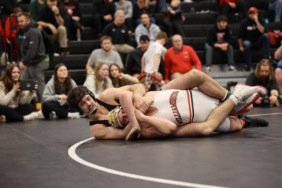 Junior Ethan Wood gets a secure hold on his opponent before pinning him. With this win, Wood placed first at 285.