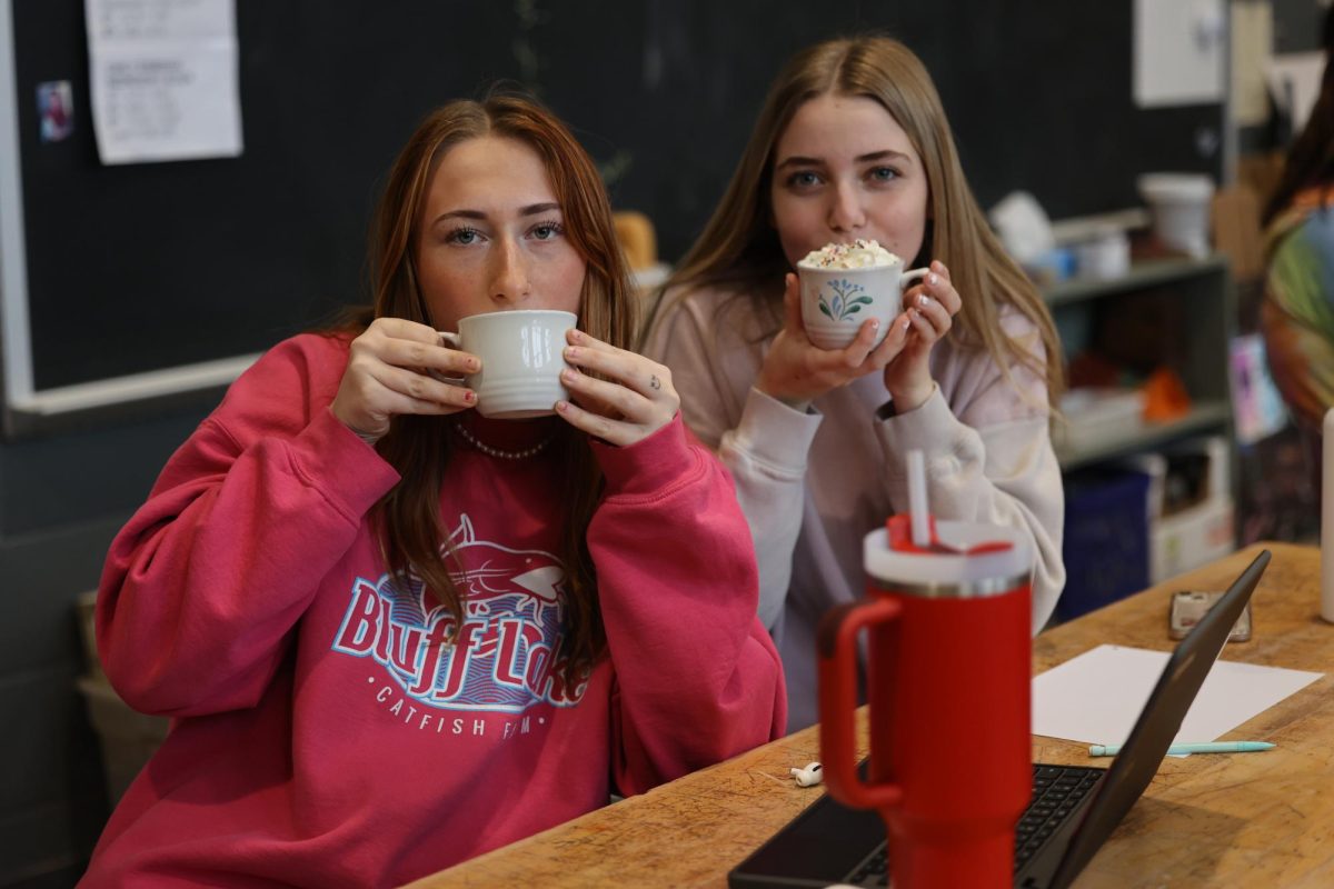 Sophomores Dakota Macchione and Alyssa Bohlken sip hot chocolate during Collaborative Expression Jan. 5. 
