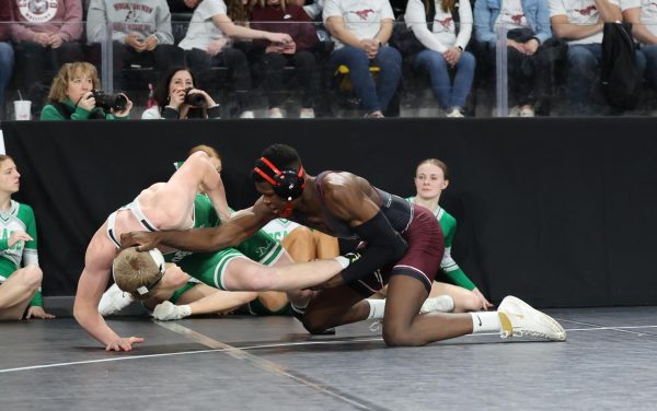 Junior Watson Krob secures the takedown on the edge of out of bounds. Krob beat his Osage opponent by fall 3:33. 