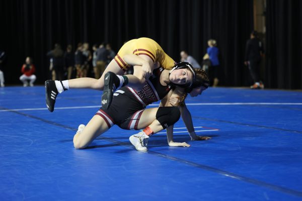 Sophomore Kiersten Swart utilizes a firemens carry to get the pin. Swart placed first to advance to state Feb. 1-2. The girls super regional was on Fri., Jan. 26. 