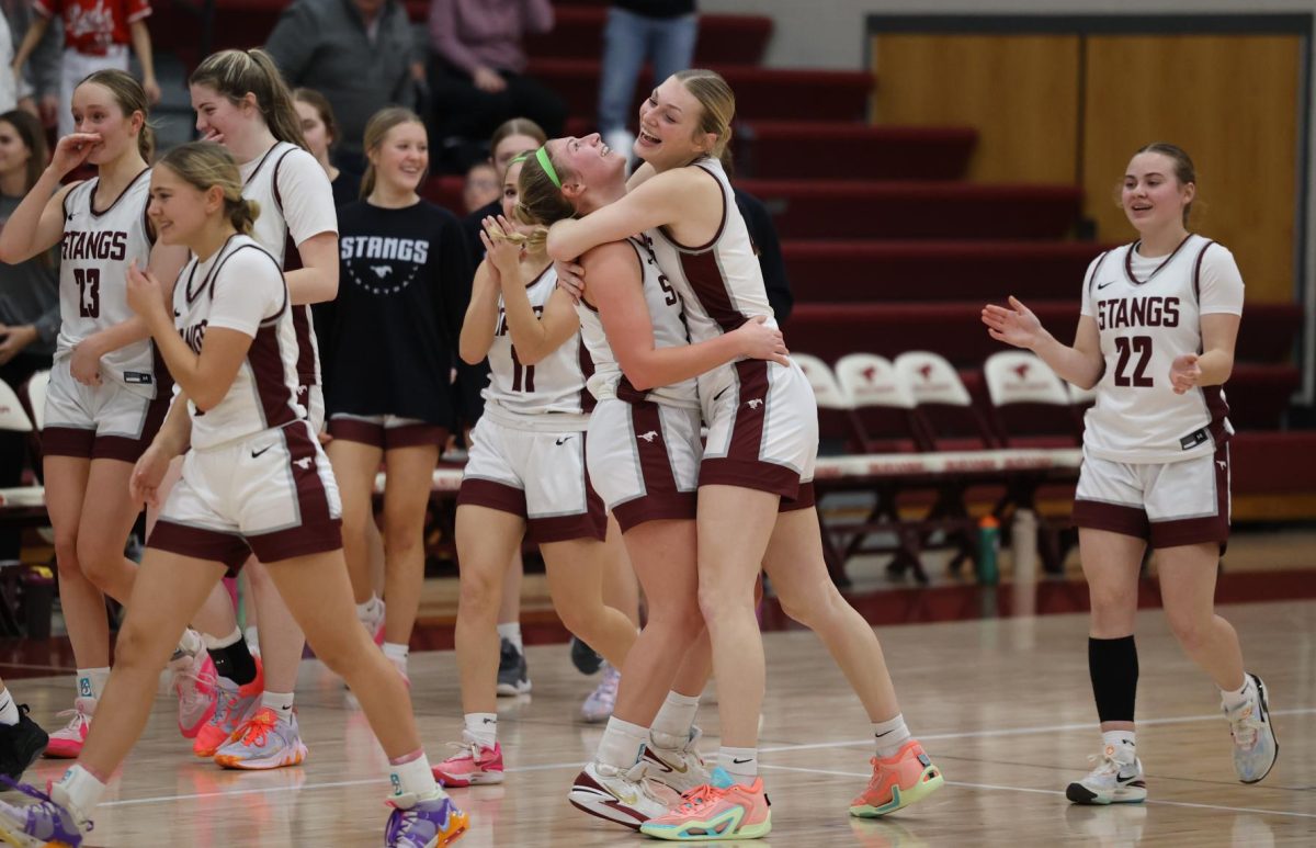 The team celebrates their win against Davenport on Feb. 14. The Mustangs won 47-37 over the Assumption Knights and will play Mediapolis on Saturday, Feb. 17 at 7 p.m.