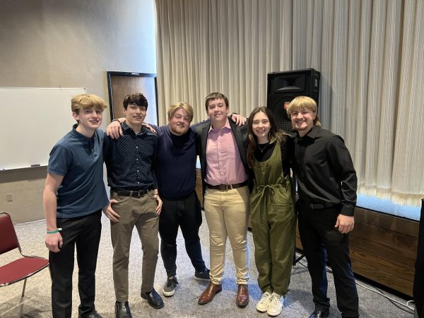 Members Nathan Conrad, Charlie Weldon, Will Errington, Claire Nydegger, and Jayce Pendergrass pose with their coach Milo Onlinger after a successful presentation of their Tv News performance. 