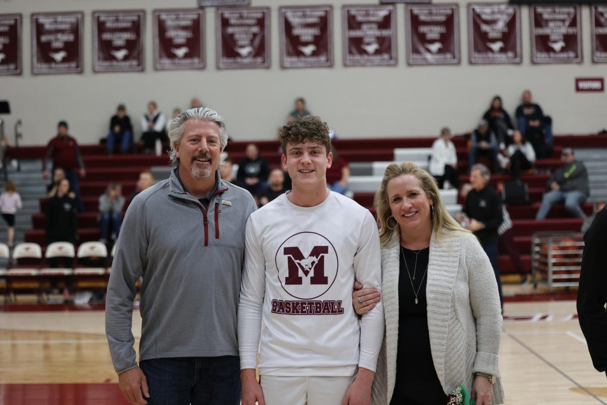 Cooper Parks with his parents on senior night. 