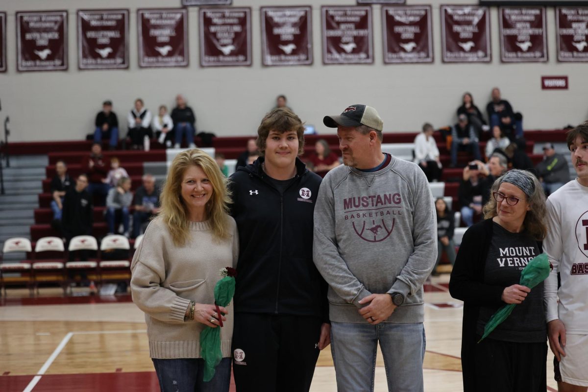 Lukas Schrock with his parents on senior night. 