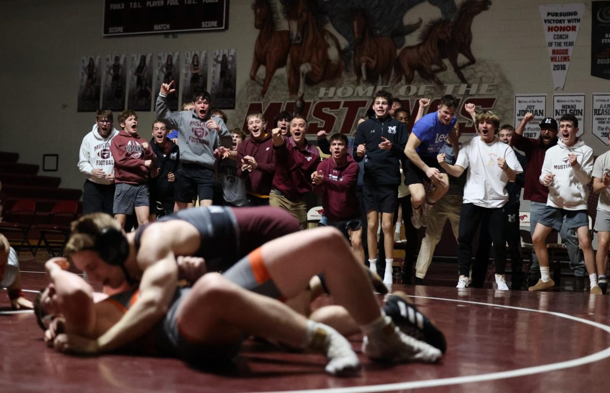 The bench in hyped after Junior Kael Rinikers pin.