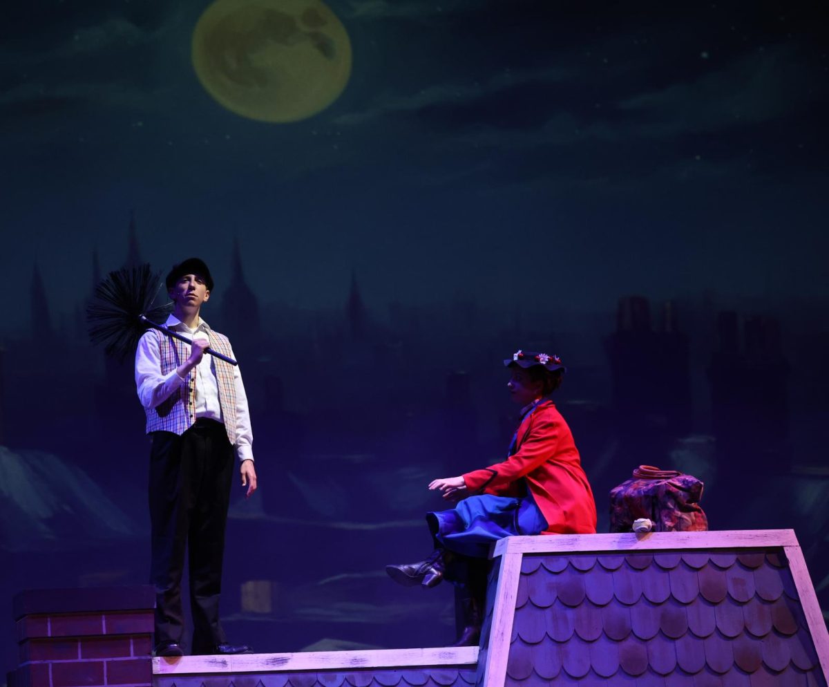 Seniors Luke Stephens (Bert) and Charlotte Krob (Mary Poppins) share a somber moment on the rooftop. 