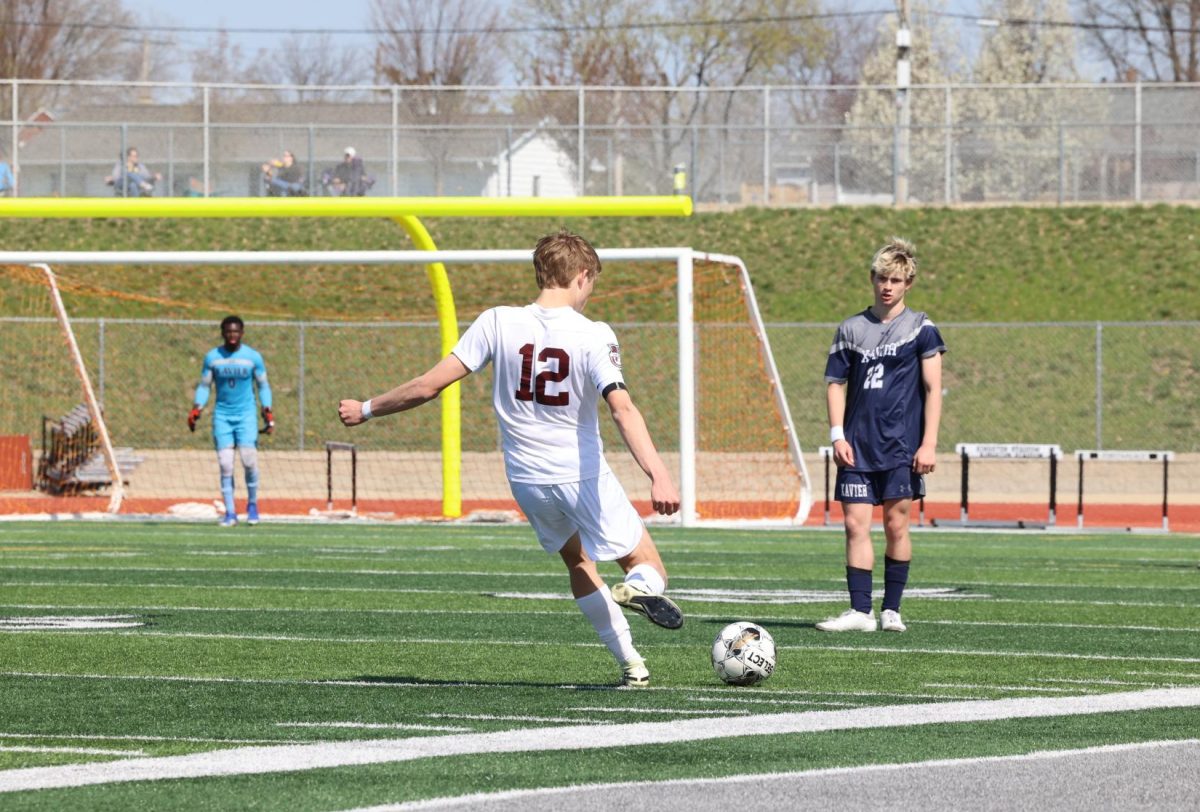 Junior captain Gavin Plathe (12) takes a free kick from midfield against Xavier on April 13th at Kingston Stadium. The Mustangs lost to the Saints 2-0. 