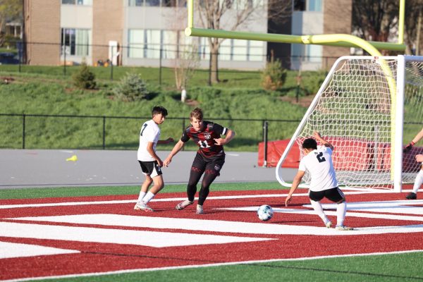 Senior Lukas Schrock (11) defends his goal from two South Tama attackers on April 23rd. 