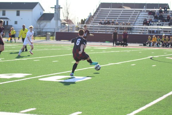 Sophomore Cash Luneckas (6) passes the ball across the field to his teammate on April 9th versus Marion. The Mustang boys lost 7-0.