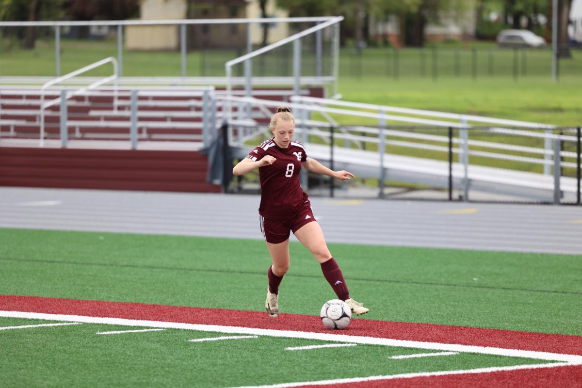 Isabelle Logue (8), a sophomore,  dribbles the ball down the sideline during the game against Williamsburg on May 2nd. The Mustangs won 3-0 at home. 