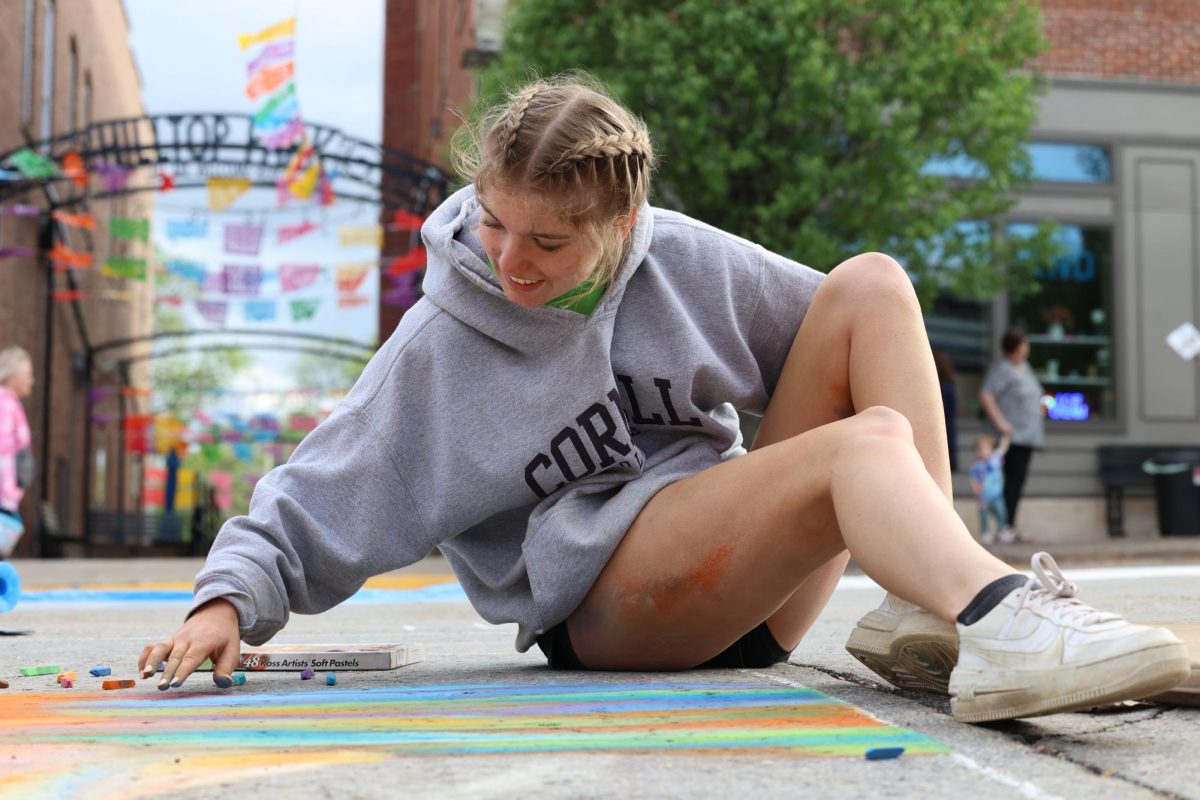 Senior Anna Vavricek works on blending colors with her fingers at Chalk the Walk on May 4th. 