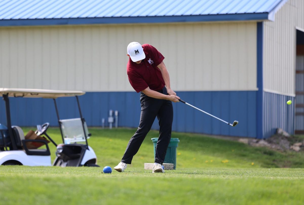 On the 12th hole, junior AJ McDermott follows through after making contact with the ball on Monday, May 6th at the WAMAC Conference golf meet. 