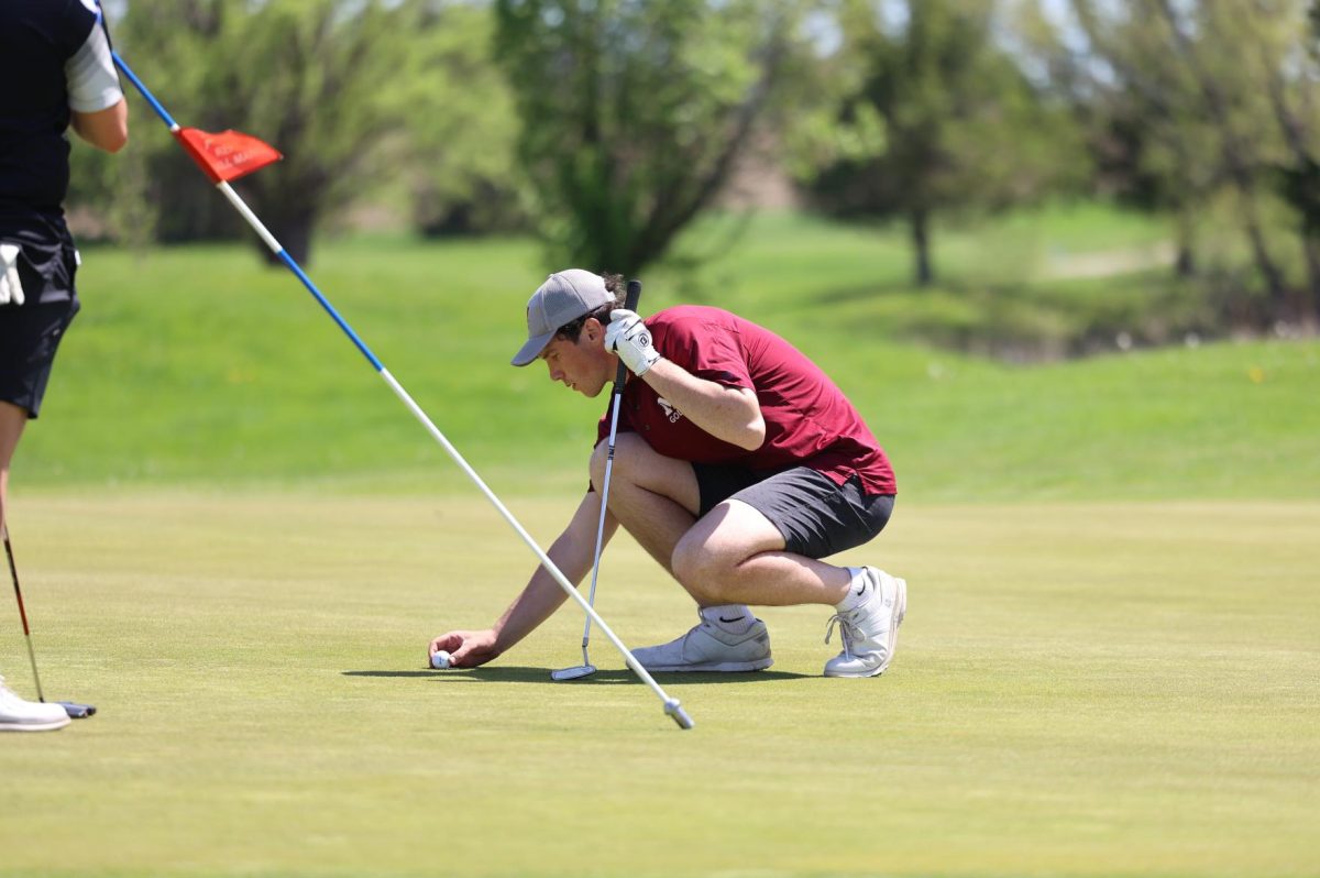 Senior Joey Rhomberg lines up his putt on his final hole of the day, hole three, at the WAMAC Conference meet May 6th. 