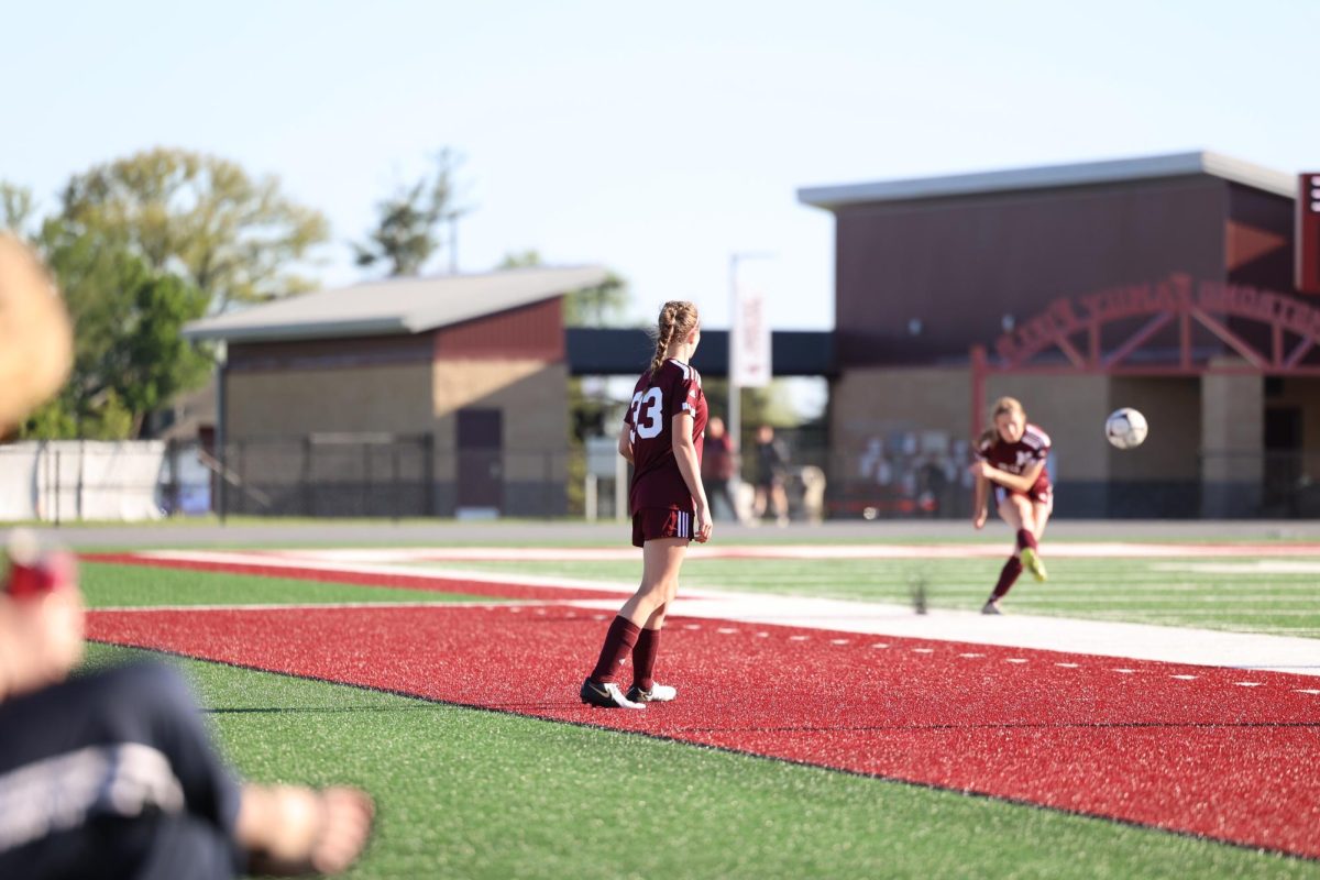 Sophomore Lilly Cook (33) watches on as her teammate takes a free kick against West Delaware on May 7th.