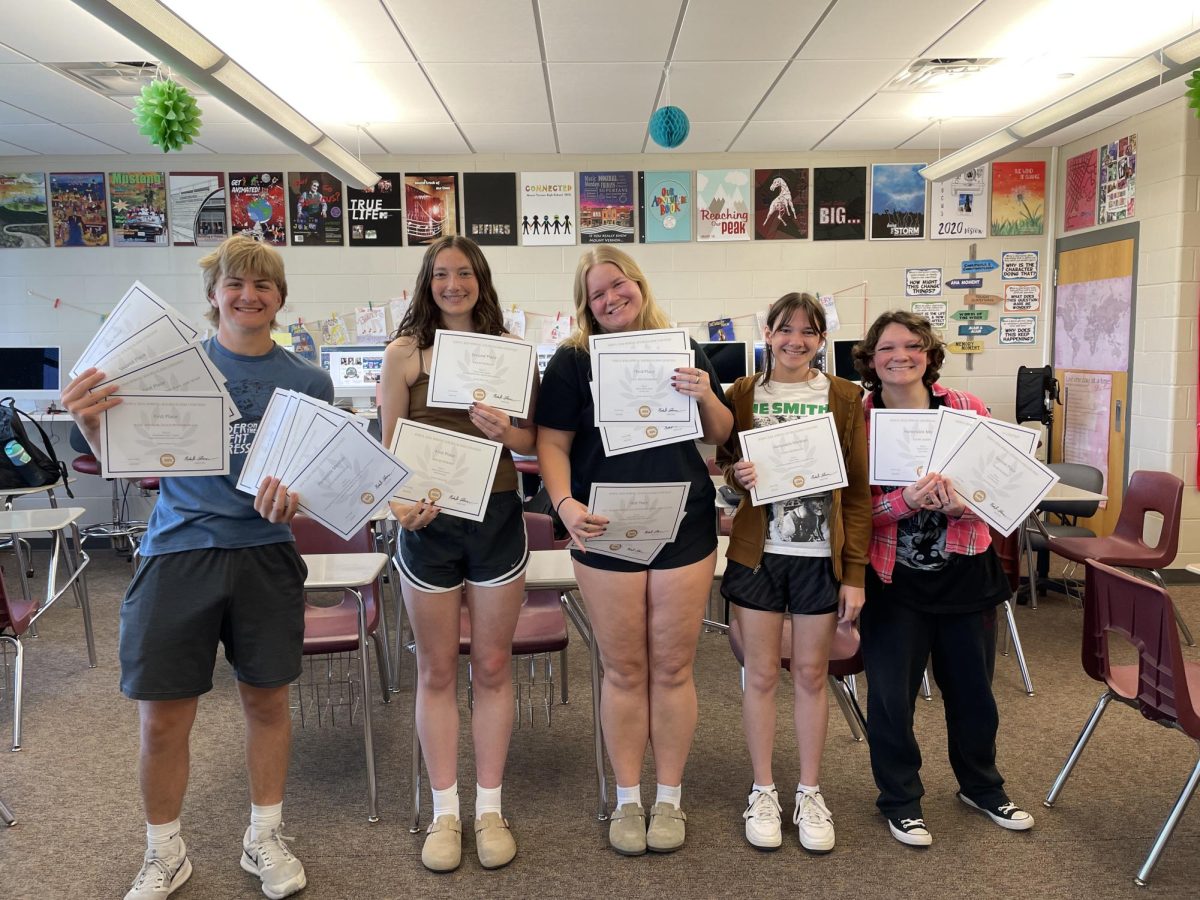Publication and Design students hold their individual awards from the IHSPA Spring News Contest. Pictured are Jayce Pendergrass, Renae Woods, Lily Rechkemmer, Kade Kaiser, and Lydia Marshall.