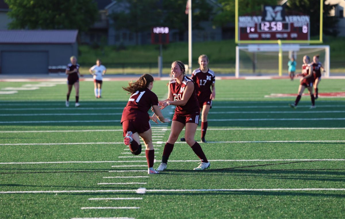 Sophomore teammates Addi Whisner (20) and Lillian Gaiser (21) of Lisbon, celebrate after Gaisers goal on May 17th at home against Oskaloosa. Mount Vernon won 9-0 and advanced to the state regional semifinal. 
