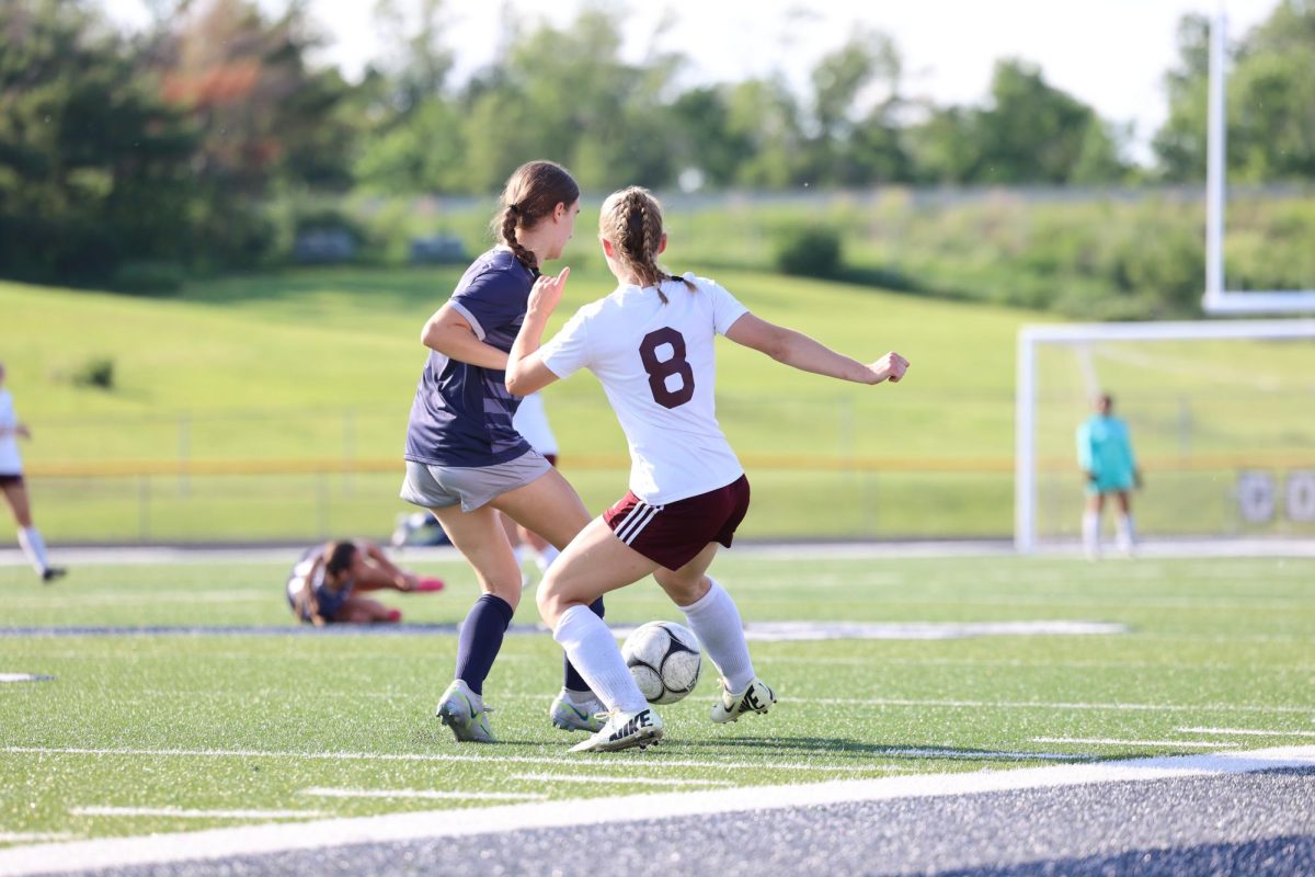 Sophomore Isabelle Logue (8) kicks the ball away from a Xavier foward on May 22. Mount Vernon lost 3-0 in the substate semifinal and finished the season 10-8. 