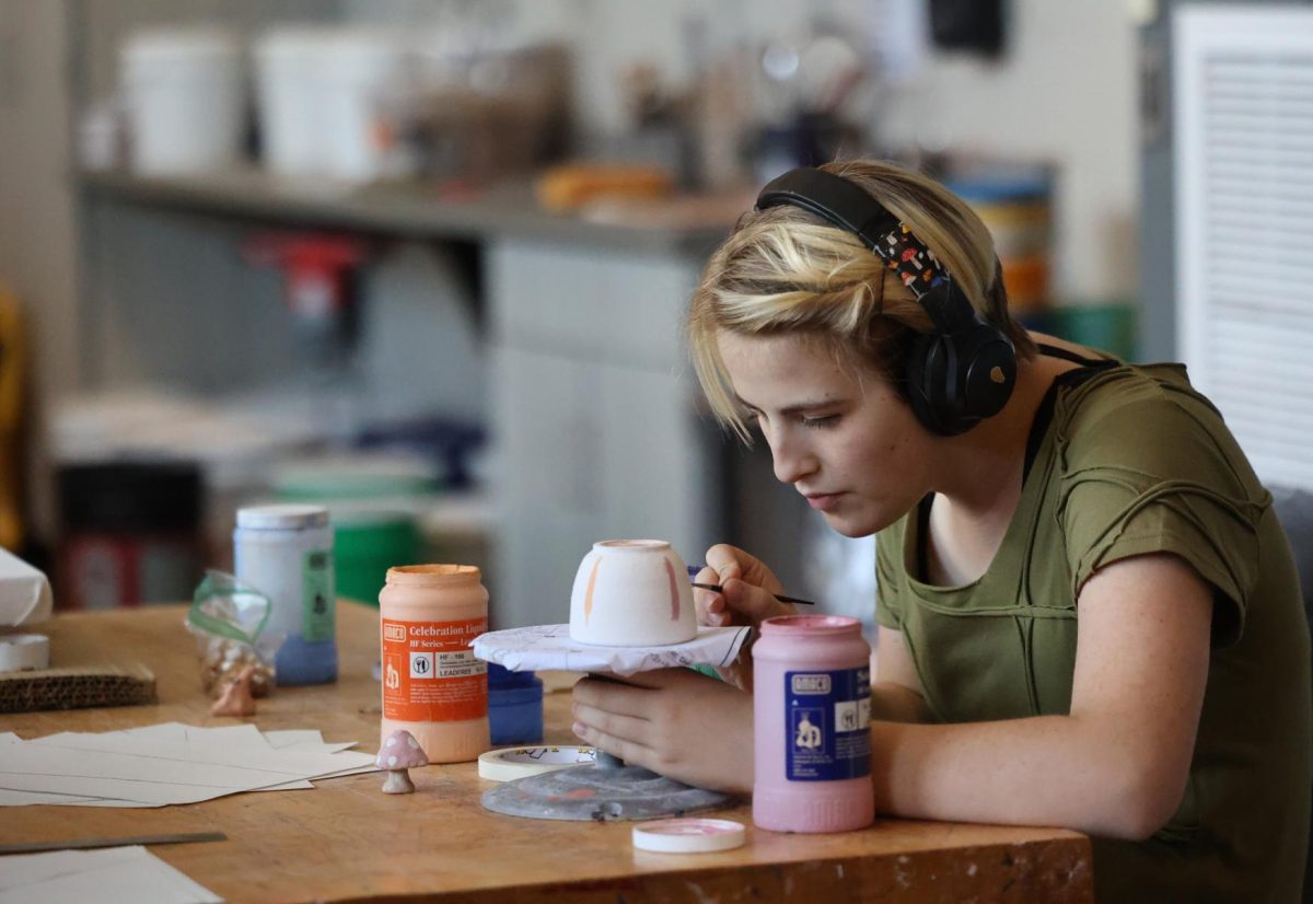 Senior Zara Larsen intricately paints glaze on a cup for her ceramics class on Aug. 28. 