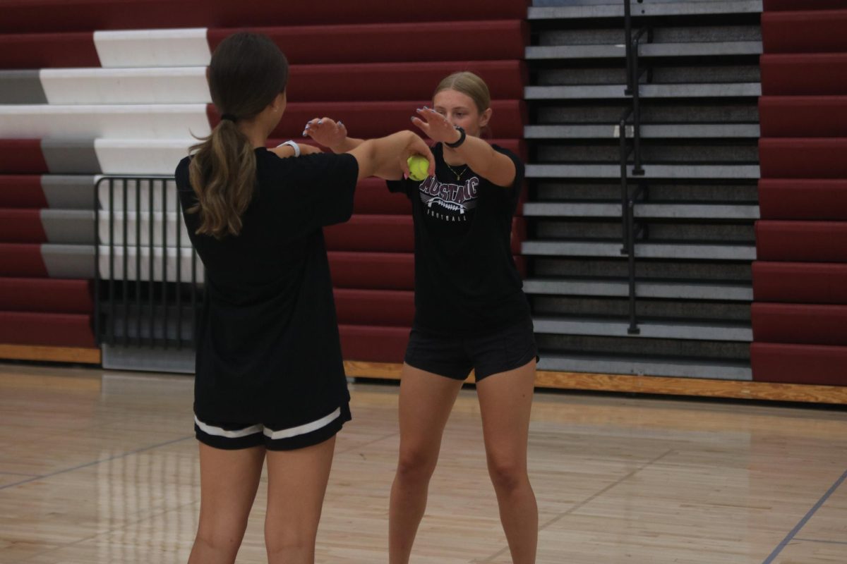 Senior Betsy Louwagie and sophomore Lucy Wischmeyer practice their hand-eye coordination with tennis balls in gym Aug. 30. 