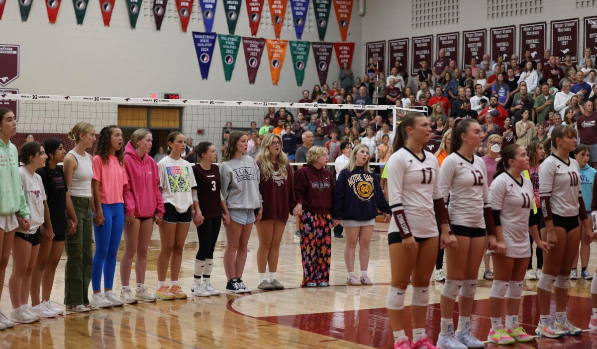 A group of choir students sing the national anthem to kick off the varsity volleyball game. Mount Vernon ended up winning 3-0 against Solon on Sept. 10.