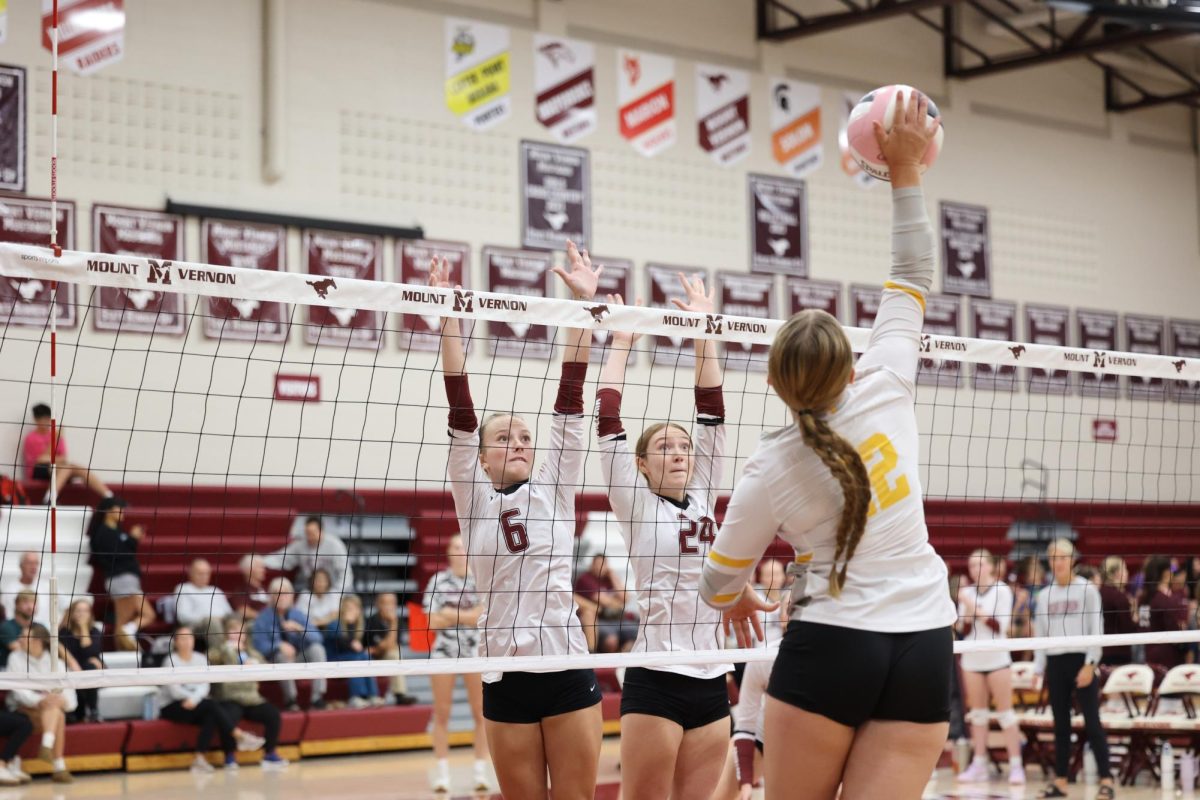 Junior Lilly Cook(6) and Sophomore Alaina Pospicil (24) blocks CPU hitter on Sept. 24.