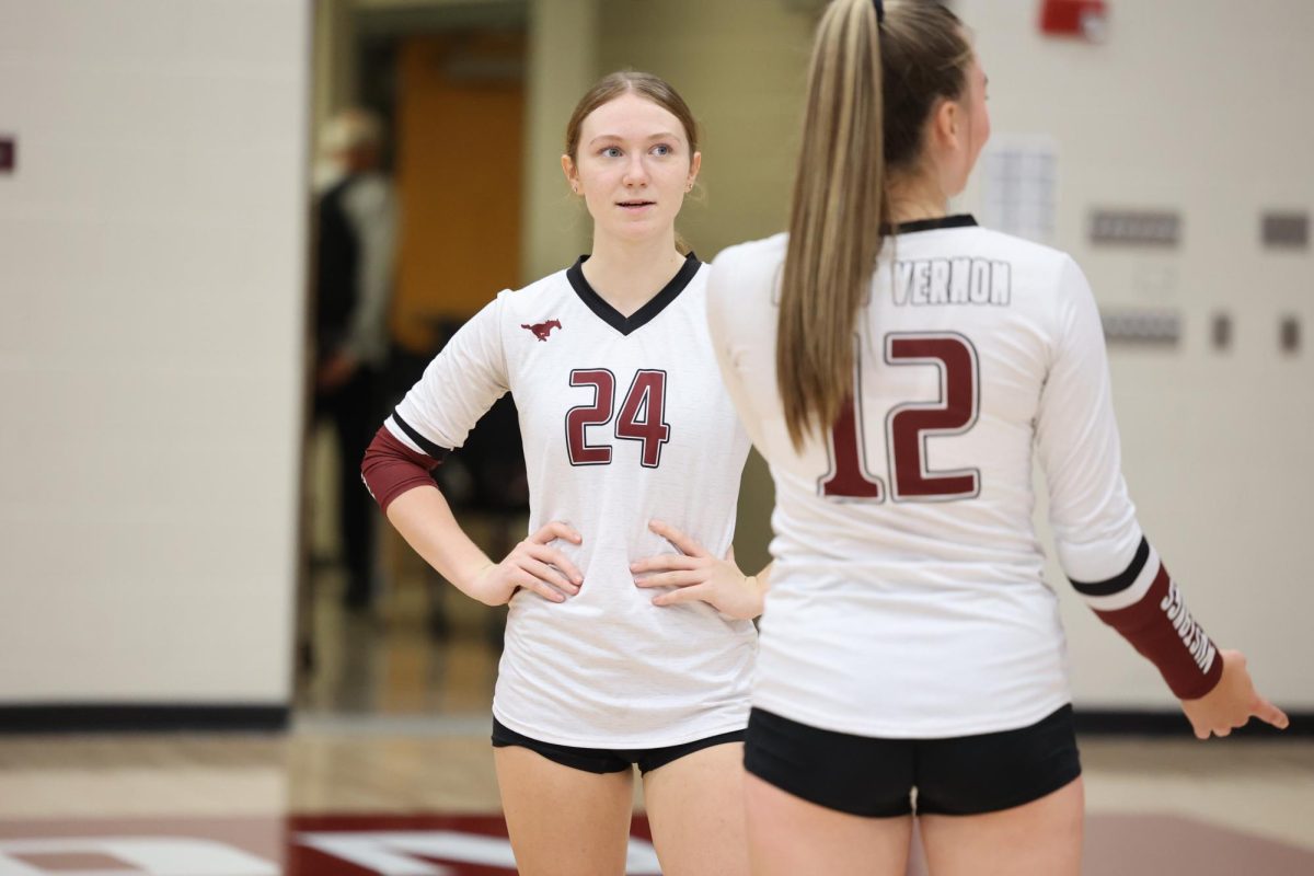 Sophmores Alaina Pospisil and Brynlee Bettcher converse during Volleyball game up against CPU on Sept. 24th.