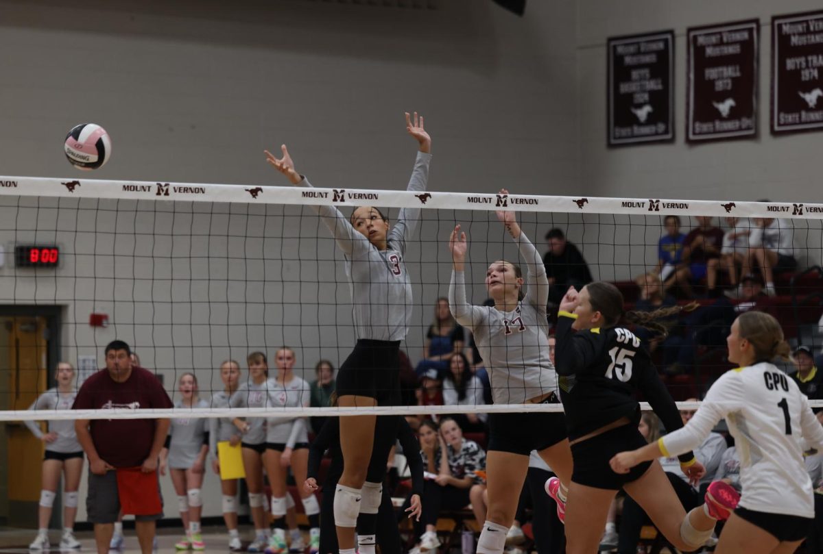 Junior CaliAna Whitaker (3) and sophomore Sophia Meester (17) jump to the side to block the ball Sept. 24.